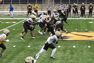 UAPB players begin running a play during an April 6 football practice. (Pine Bluff Commercial/Tanner Spearman)